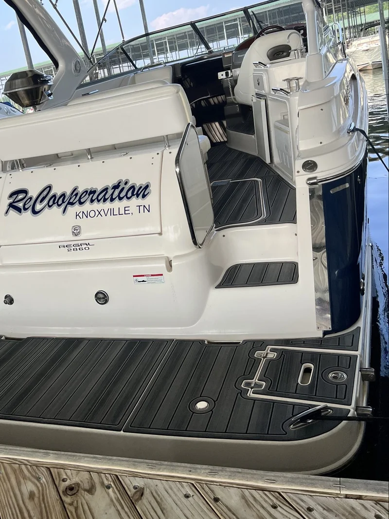Teak GatorStep swim platform on a dark-hulled cruiser from Knoxville, TN