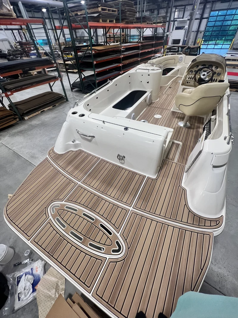 Curved teak GatorStep swim platform and rear deck on a cabin cruiser