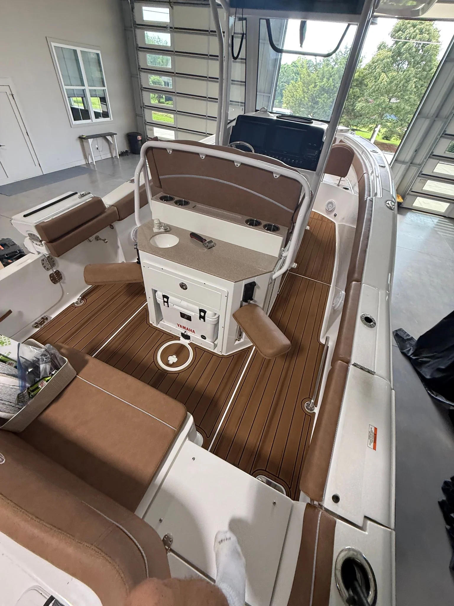 Brown teak-pattern GatorStep flooring in a center console cockpit — Lakebound Marine, Lenoir City TN