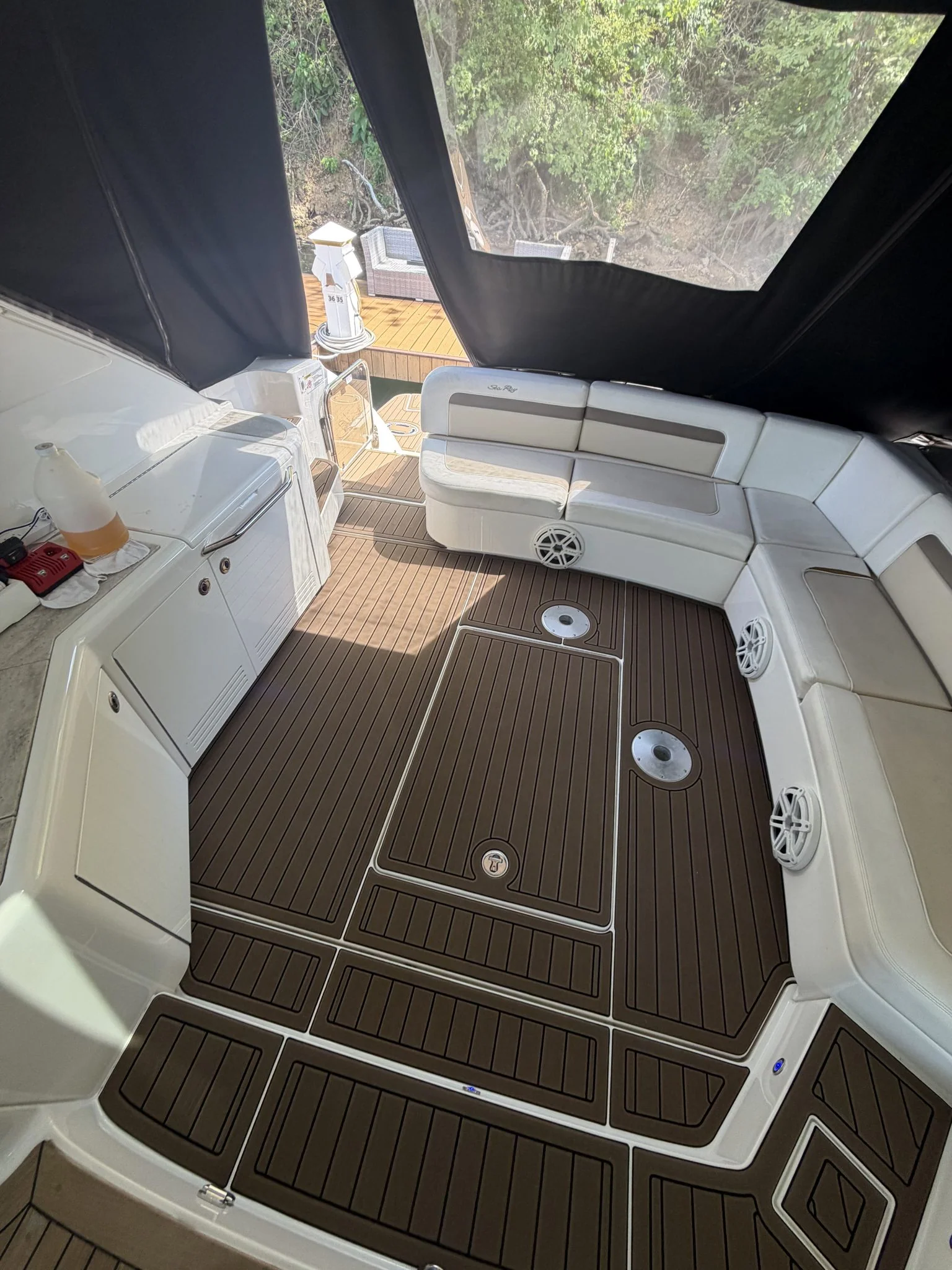Tan teak GatorStep cockpit flooring in a cruiser with white seating