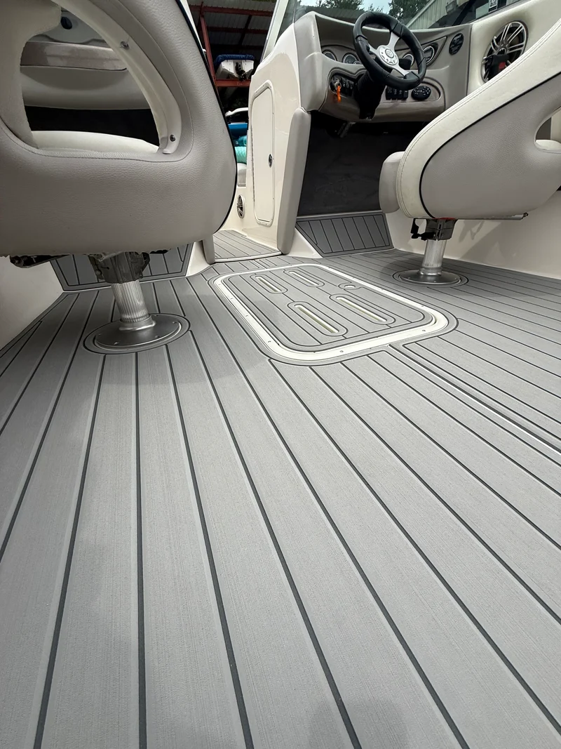 Light gray teak-groove GatorStep cockpit flooring with routed helm mat