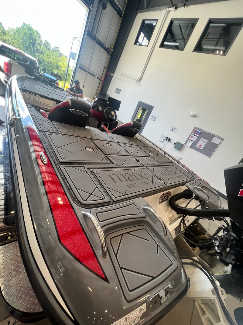 Charcoal GatorStep front deck installed on a red bass boat