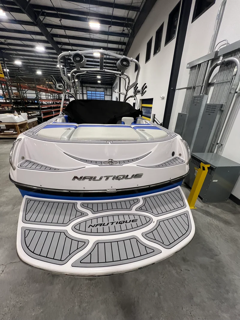 Gray teak GatorStep swim platform on a Nautique wakeboat