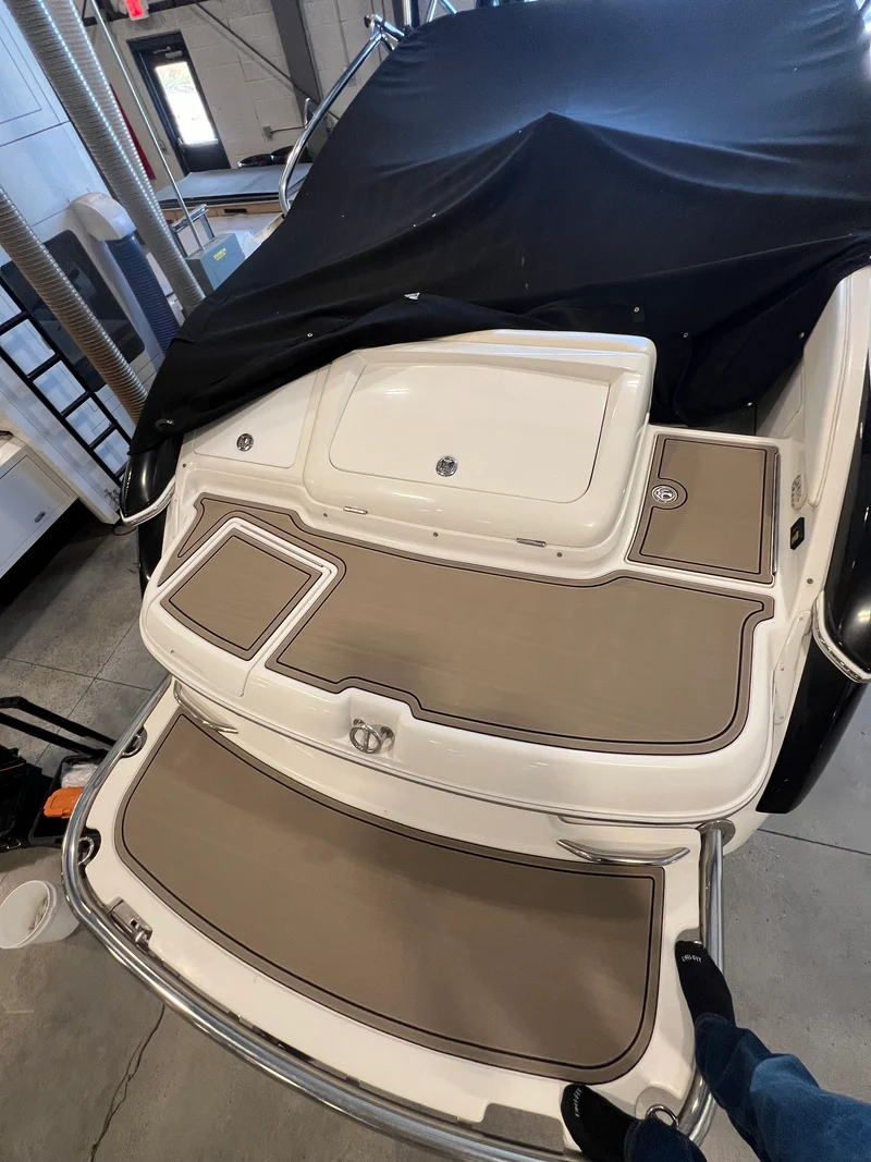 Two-tone tan GatorStep pads on a boat swim step and ladder