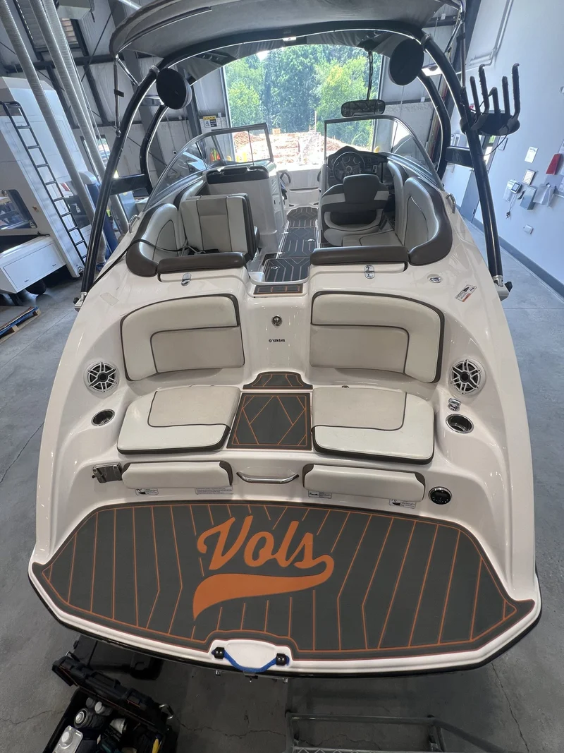 Tan teak GatorStep cockpit flooring in a white bowrider