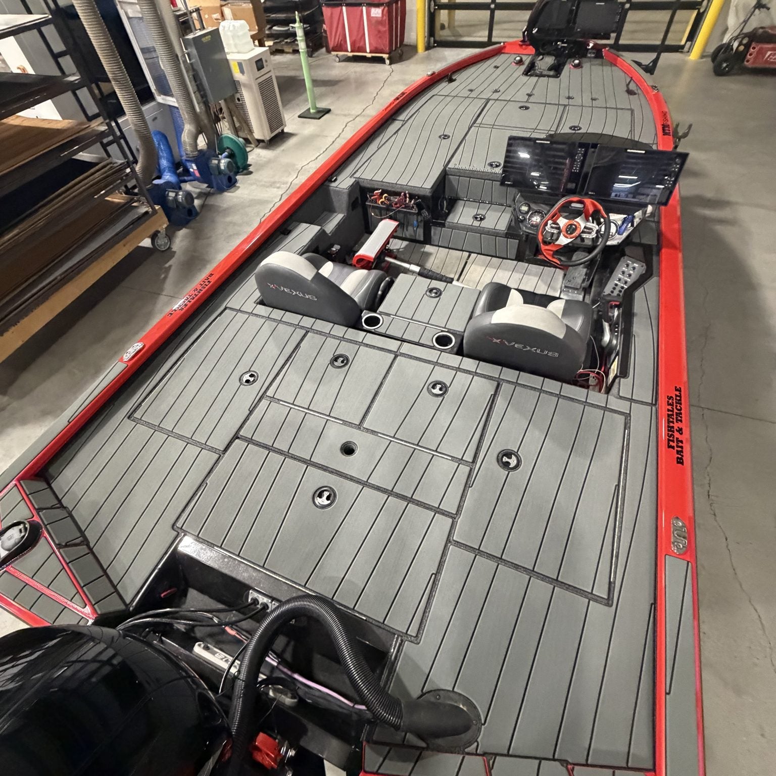 Gray GatorStep cockpit flooring in a red and black bass boat