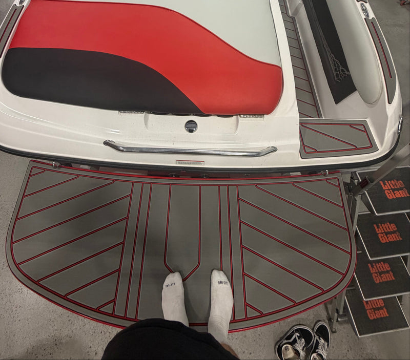 Gray GatorStep swim platform pad with red trim on a red and black boat