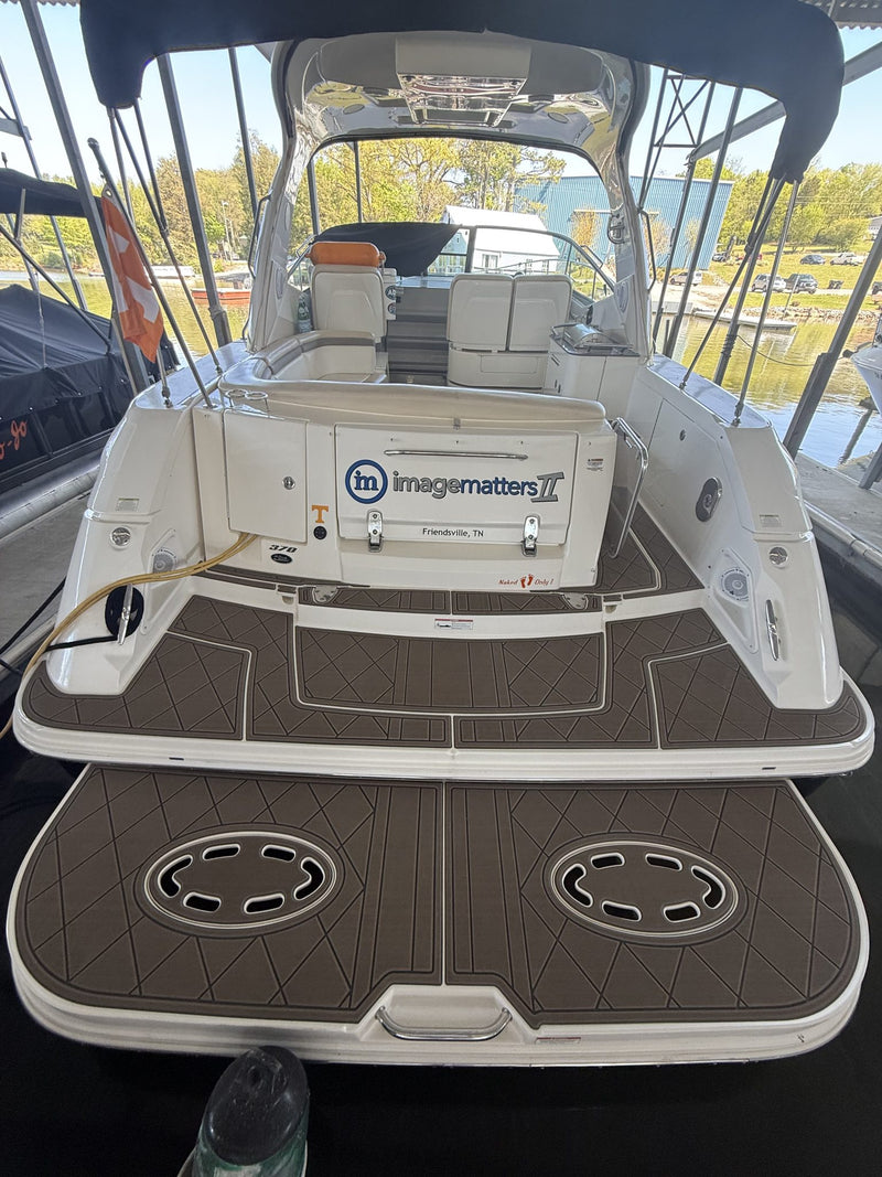 Teak GatorStep swim platform on a white cruiser transom