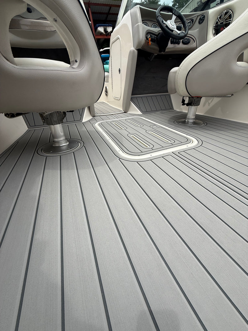Light gray teak-groove GatorStep cockpit flooring with routed helm mat