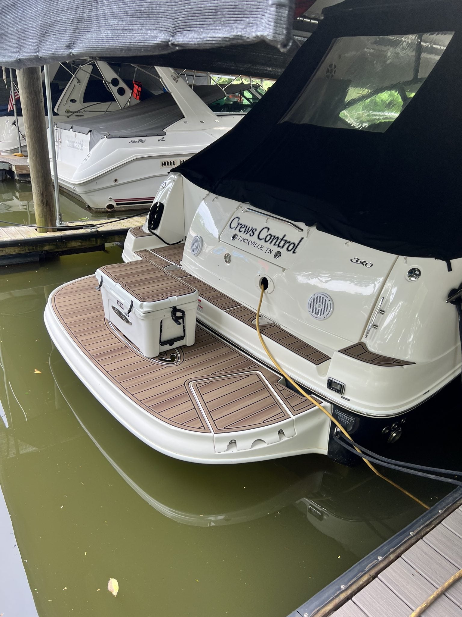 Custom GatorStep swim platform with logo inlay on a cabin cruiser