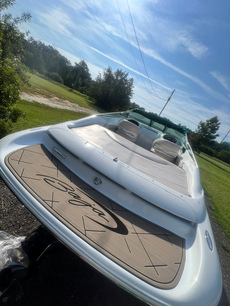 Tan GatorStep bow decking with script logo on a bowrider at the lake
