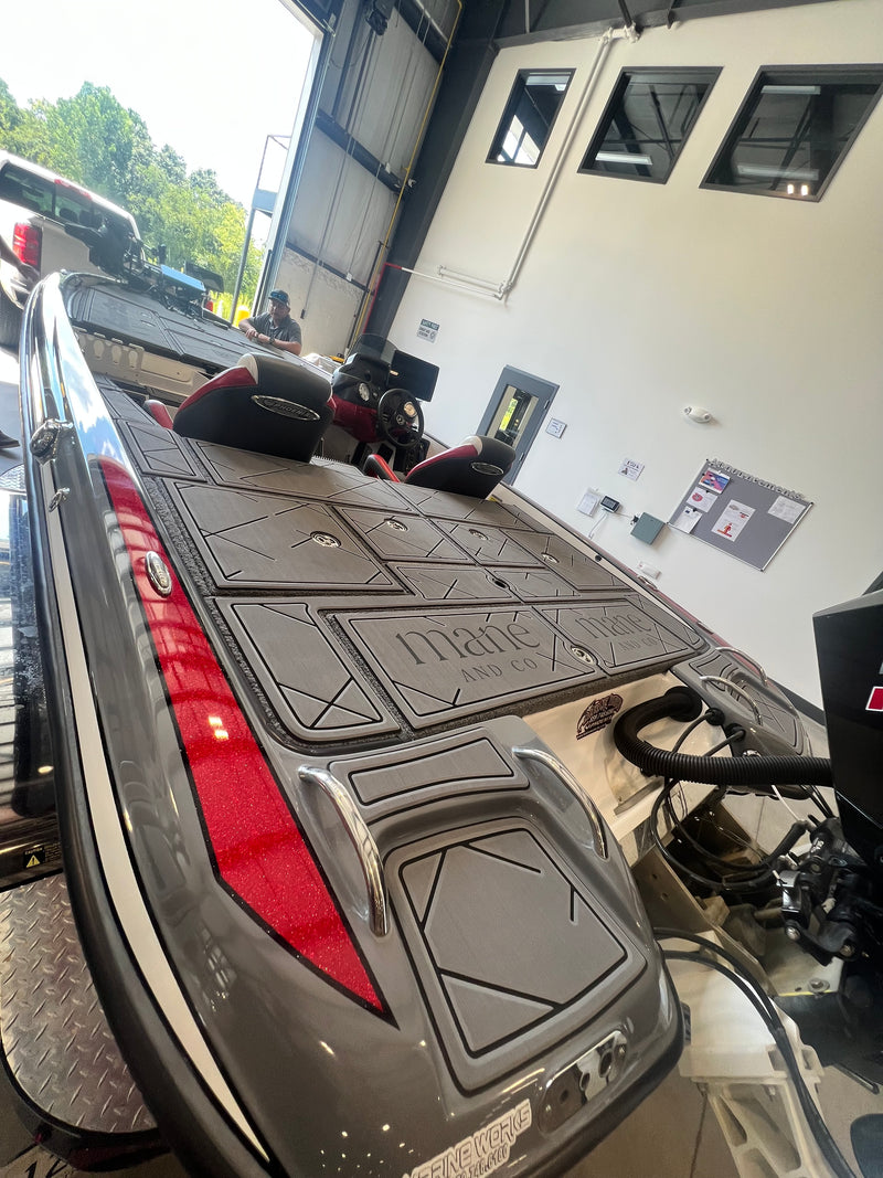 Charcoal GatorStep front deck installed on a red bass boat