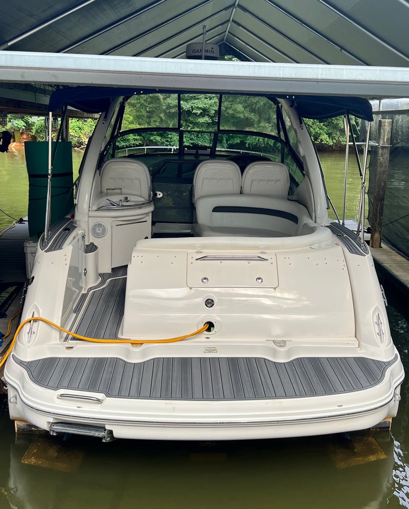Gray teak GatorStep swim platform and engine hatch on a white boat
