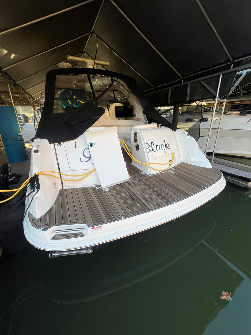 Brown teak GatorStep bow deck on a cruiser at the marina
