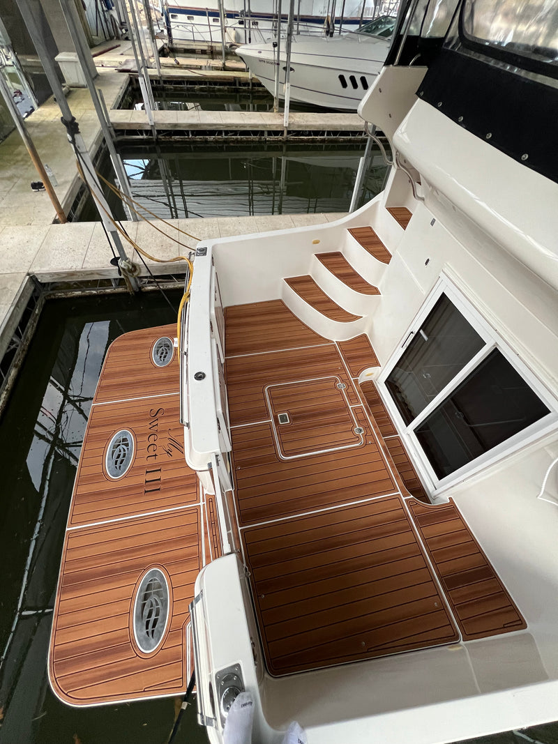 Teak GatorStep steps and walkway on a docked cruiser