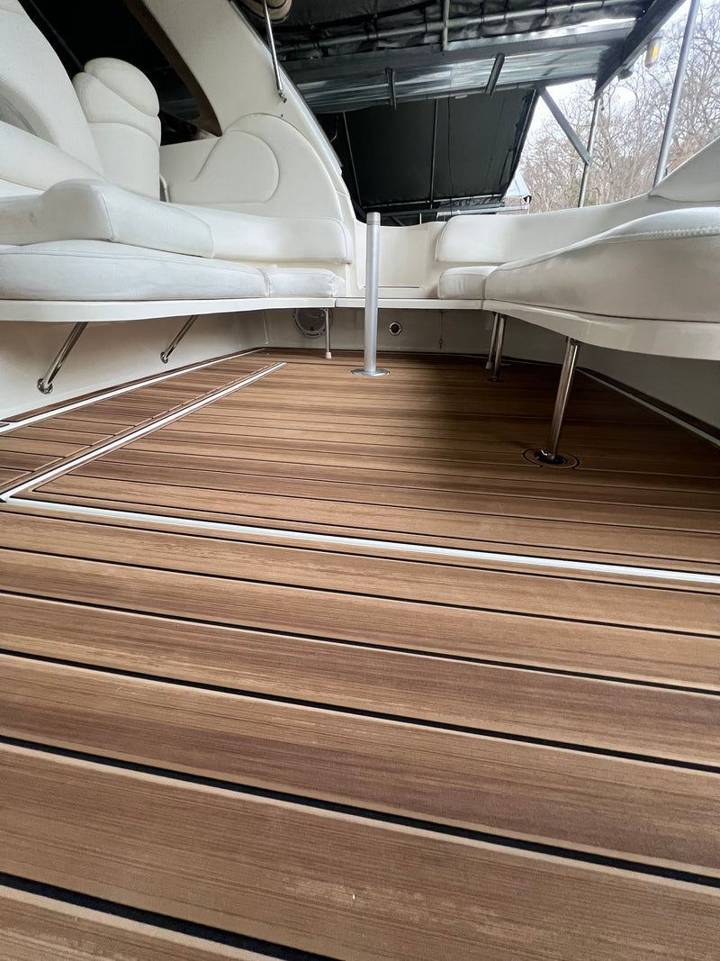 Tan teak GatorStep floor in a white boat cockpit