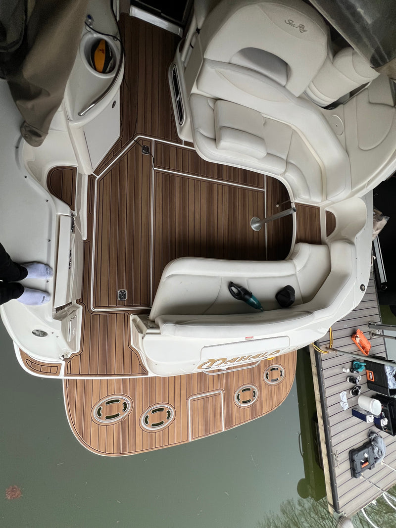 Woodgrain teak-style GatorStep flooring and swim platform on a white boat