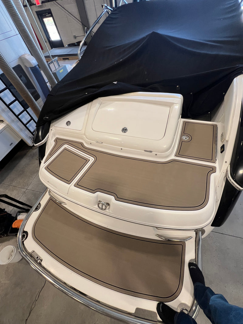 Two-tone tan GatorStep pads on a boat swim step and ladder
