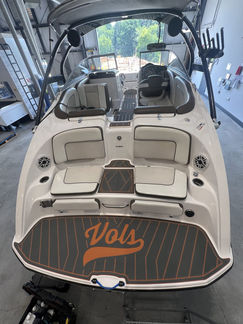 Tan teak GatorStep cockpit flooring in a white bowrider